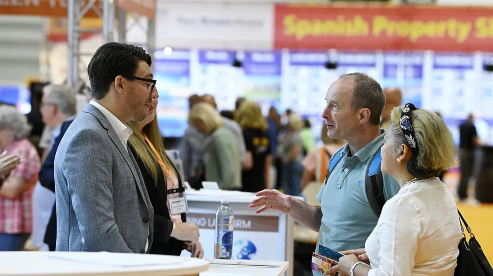 A place in the sun live property show UK, exhibitor talking to visitor