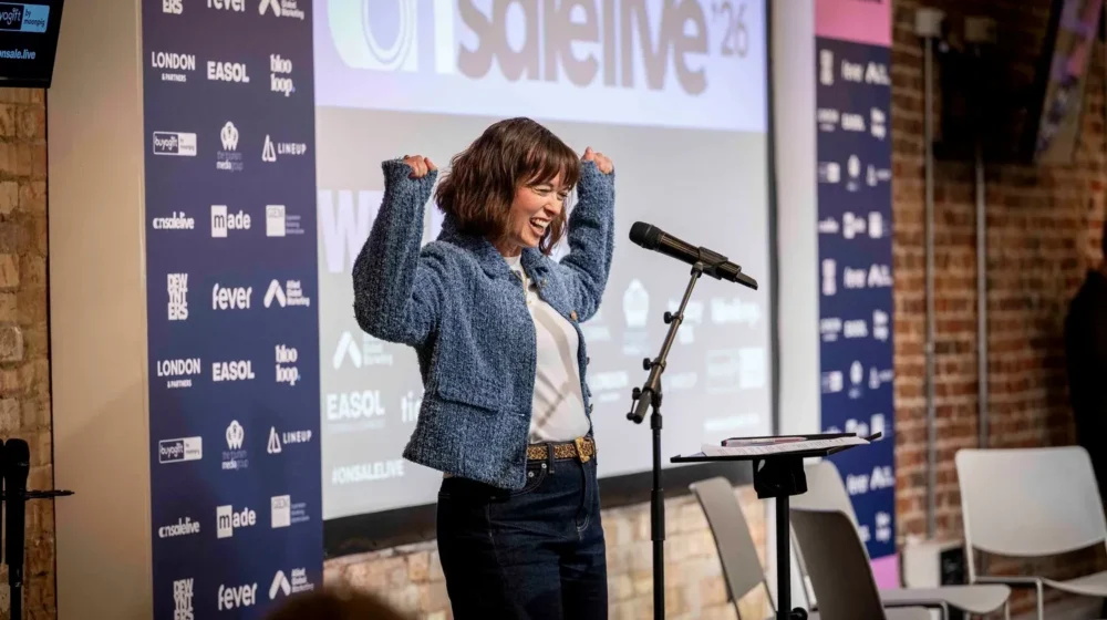 On Sale Live Experience Economy Expo Founder Dawn Farrow on stage speaking at an event