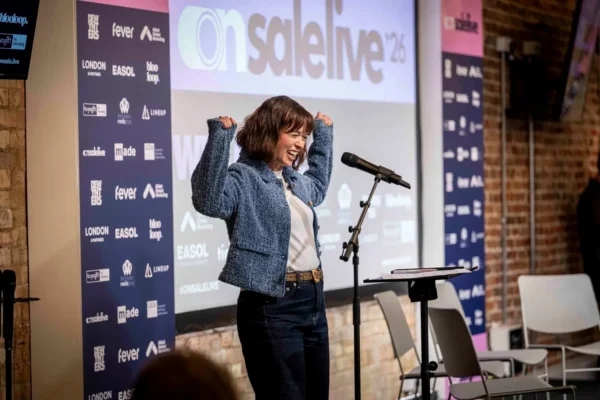 On Sale Live Experience Economy Expo Founder Dawn Farrow on stage speaking at an event