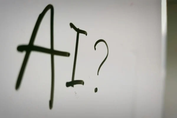 AI stock image - photo of AI written on whiteboard with question mark after it