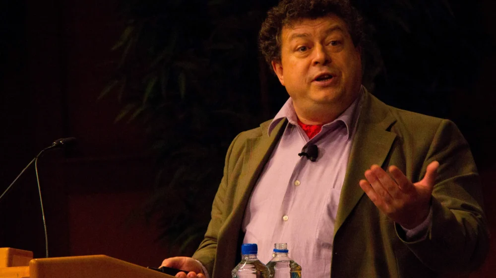 Rory Sutherland speaking at event on stage